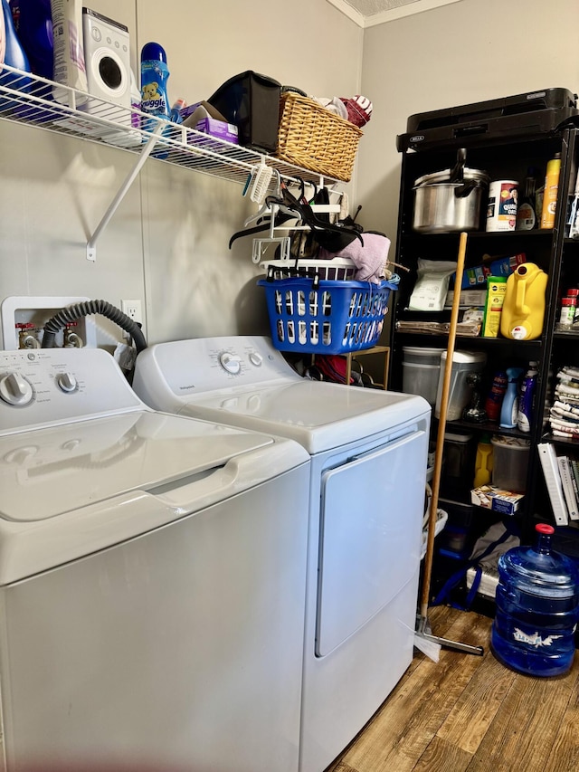 laundry room with washer and dryer and hardwood / wood-style floors