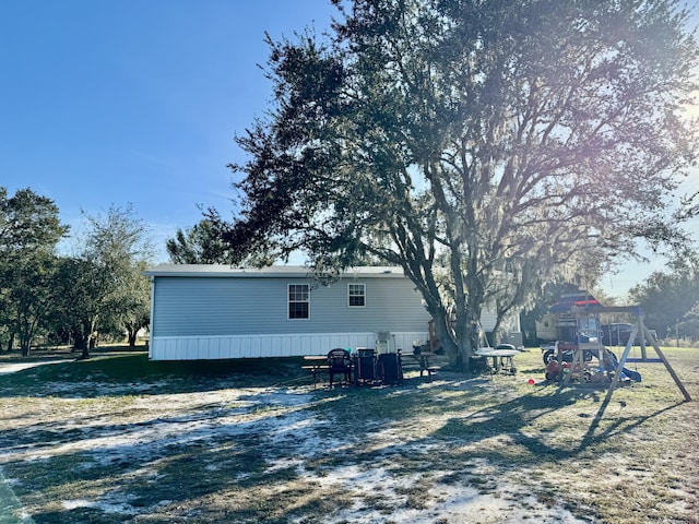 view of property exterior with a playground