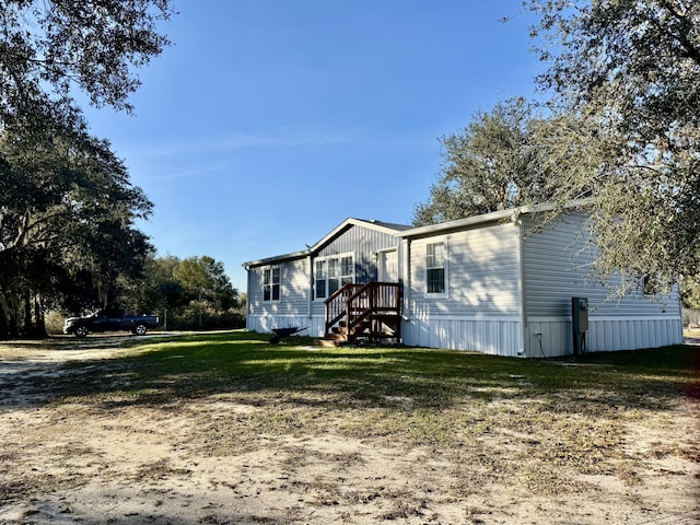 rear view of house with a lawn