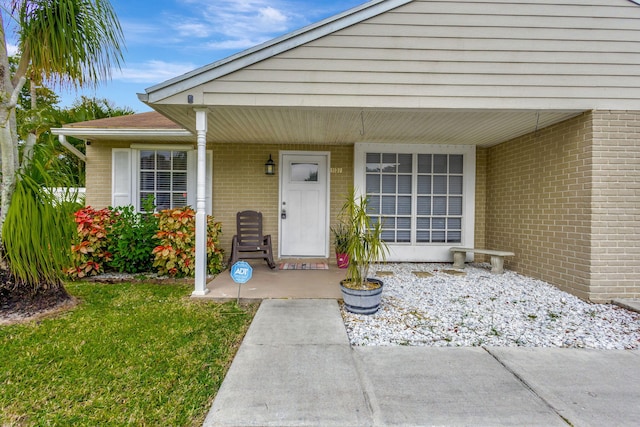 entrance to property featuring a yard