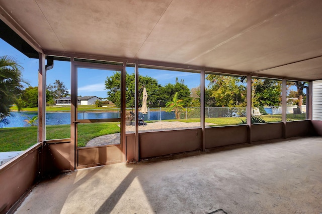 unfurnished sunroom featuring plenty of natural light and a water view