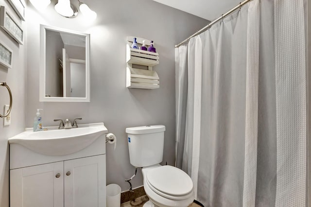 bathroom with a shower with shower curtain, vanity, and toilet