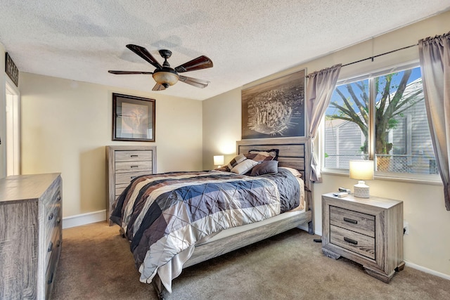 carpeted bedroom featuring ceiling fan and a textured ceiling