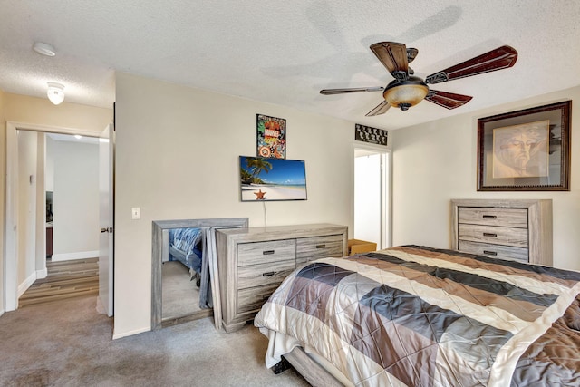 carpeted bedroom with a textured ceiling and ceiling fan