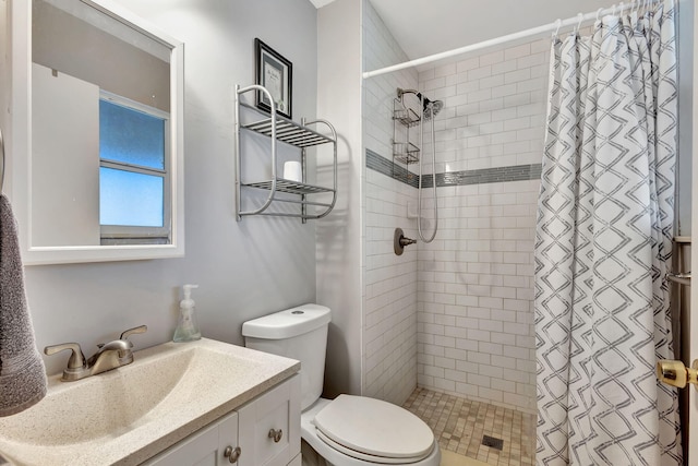 bathroom featuring a shower with curtain, vanity, and toilet