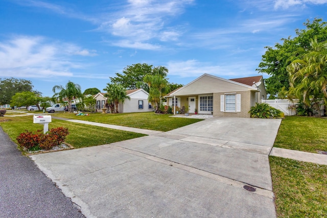 ranch-style house with a front lawn and covered porch