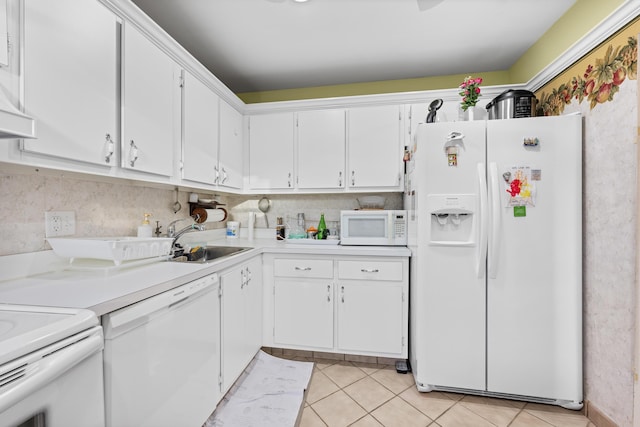 kitchen featuring light tile patterned flooring, white cabinetry, sink, and white appliances