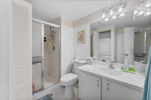 bathroom featuring toilet, stacked washer and clothes dryer, an enclosed shower, and vanity