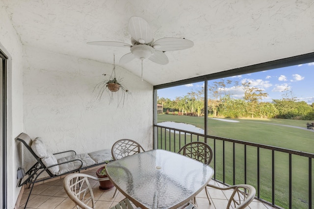 sunroom with ceiling fan and lofted ceiling