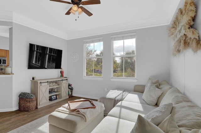 living room featuring ceiling fan, light hardwood / wood-style flooring, and ornamental molding