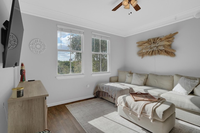 living room with crown molding, ceiling fan, and dark hardwood / wood-style floors