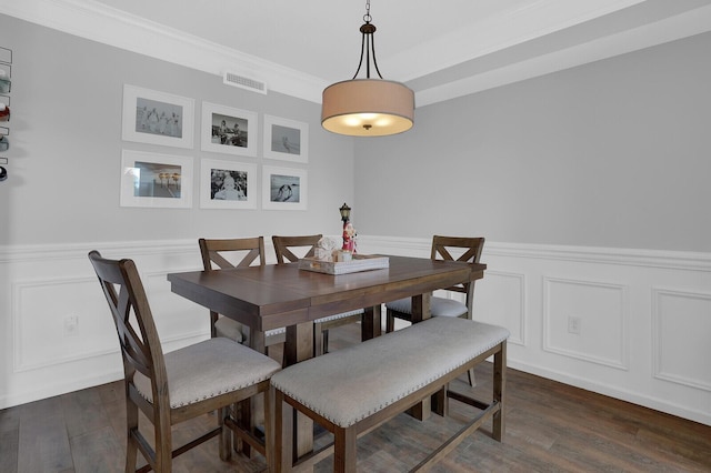 dining room featuring ornamental molding and dark wood-type flooring