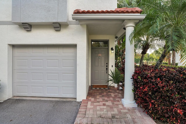 view of exterior entry with a garage