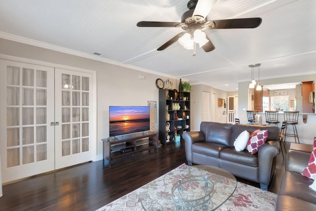 living room with dark hardwood / wood-style flooring, crown molding, and french doors