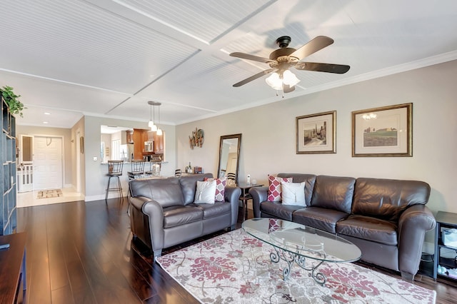 living room featuring crown molding, ceiling fan, and dark wood-type flooring