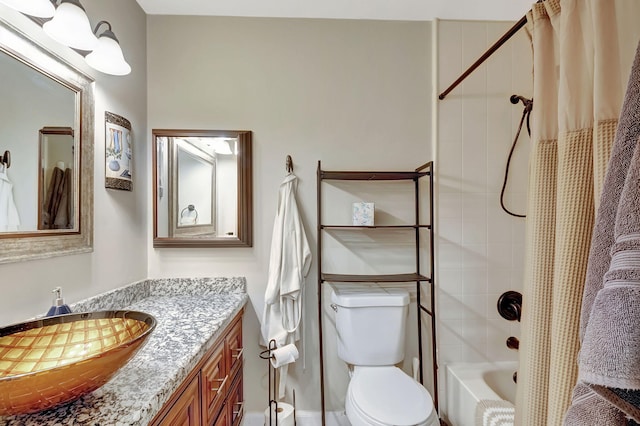 full bathroom with vanity, shower / bath combination with curtain, and toilet