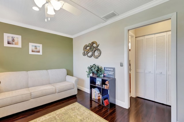 living room with ceiling fan, crown molding, and dark wood-type flooring