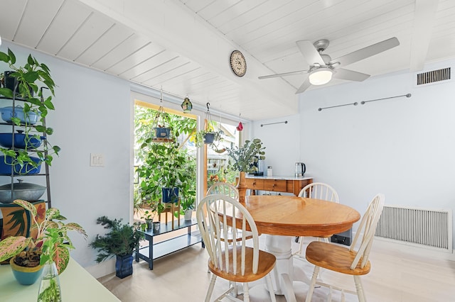 dining room with beamed ceiling, ceiling fan, light wood-type flooring, and wooden ceiling