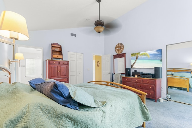 bedroom featuring ceiling fan, carpet flooring, high vaulted ceiling, and ensuite bath