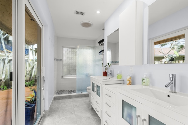 bathroom featuring vanity, toilet, and a shower with shower door