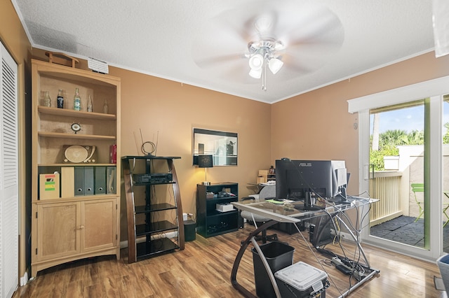 office space featuring a textured ceiling, ceiling fan, light hardwood / wood-style floors, and crown molding