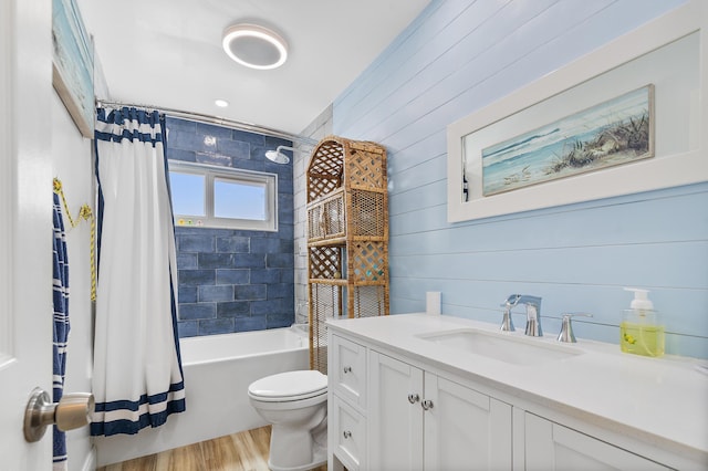 full bathroom with toilet, vanity, hardwood / wood-style flooring, and shower / tub combo with curtain