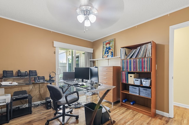 office space with a textured ceiling, ornamental molding, light hardwood / wood-style floors, and ceiling fan