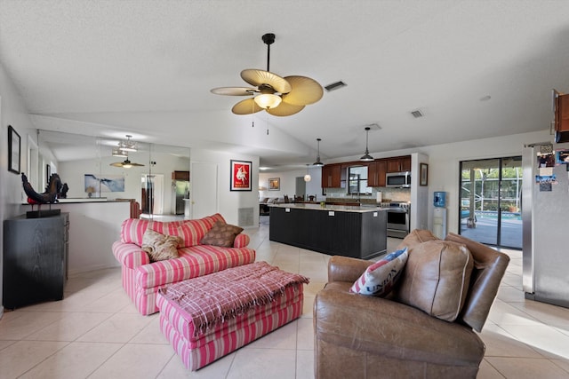 living room featuring light tile patterned floors, vaulted ceiling, and ceiling fan