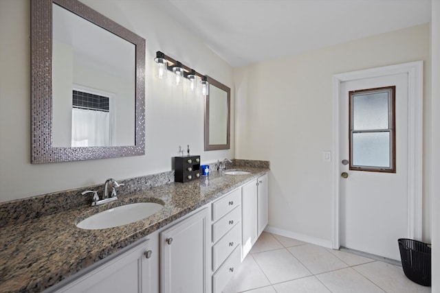 bathroom with tile patterned flooring and vanity