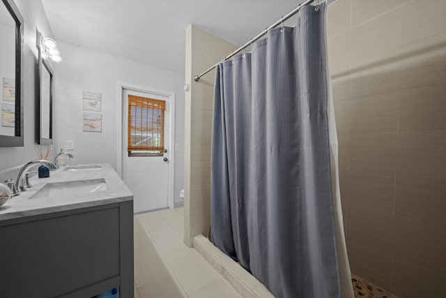 bathroom featuring tile patterned flooring, a shower with curtain, and vanity