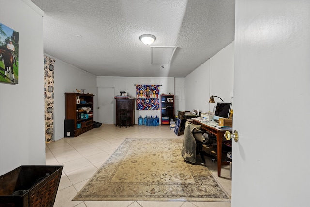 interior space with light tile patterned floors and a textured ceiling