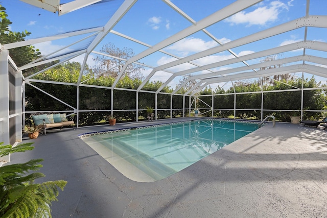 view of swimming pool featuring a patio and glass enclosure