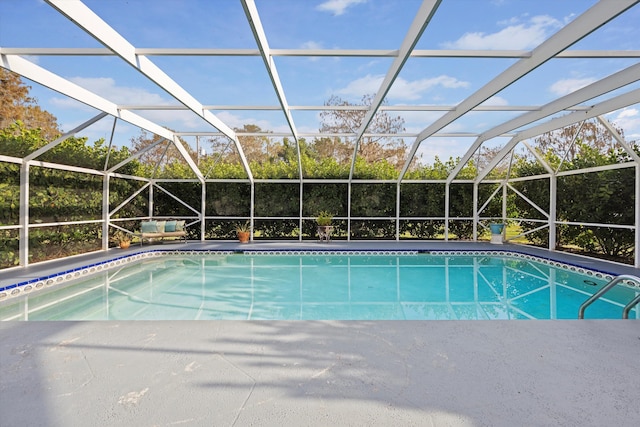 view of swimming pool featuring a lanai