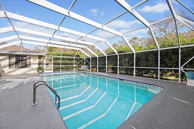 view of swimming pool with glass enclosure and a patio