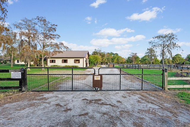 view of gate with a yard