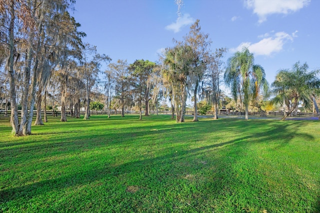 view of property's community featuring a rural view and a lawn