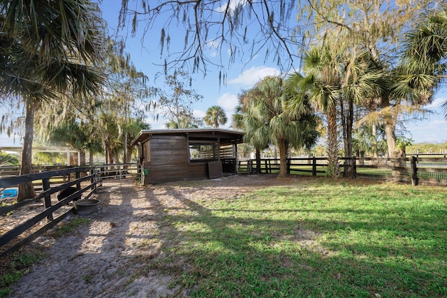 view of yard featuring a rural view and an outbuilding