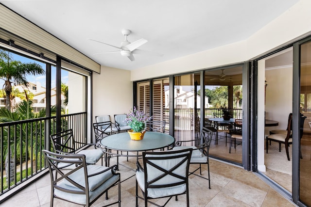 sunroom / solarium featuring ceiling fan