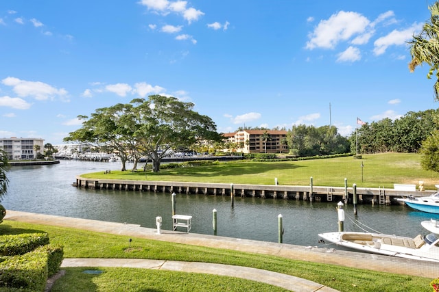 dock area featuring a lawn and a water view