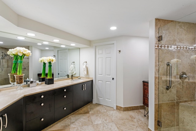 bathroom with tile patterned flooring, vanity, and a shower with shower door