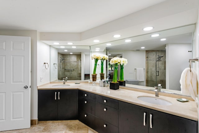 bathroom with tile patterned flooring, vanity, and a shower with door