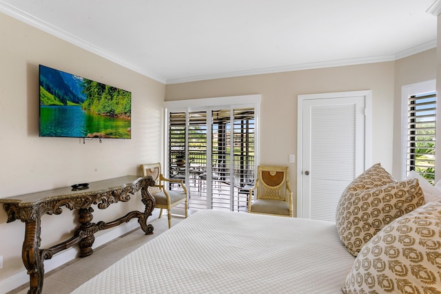 bedroom with access to outside, a closet, crown molding, and light colored carpet