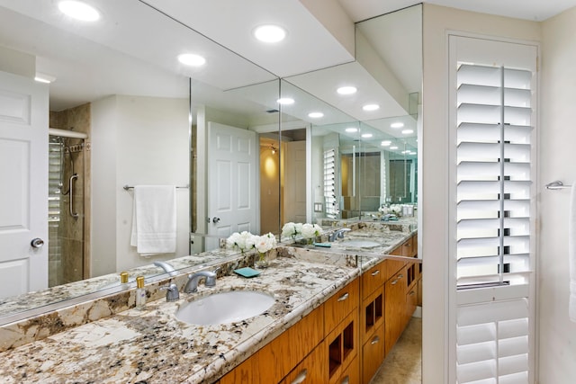 bathroom featuring vanity and a shower with shower door