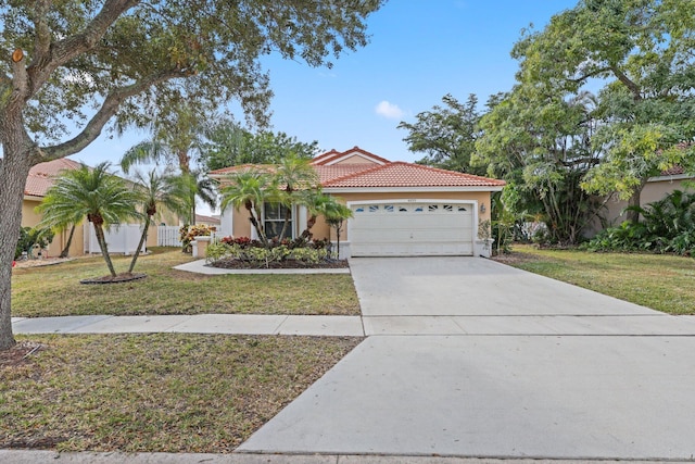 mediterranean / spanish-style home with a front yard and a garage