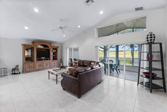 tiled living room featuring ceiling fan and vaulted ceiling