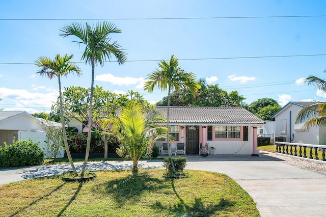 232 SW 6th Ave, Boynton Beach, FL 33435 - view of front of property with a tiled roof, driveway, and stucco siding