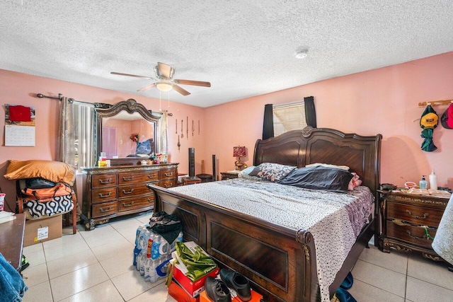 tiled bedroom featuring ceiling fan and a textured ceiling