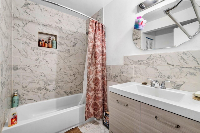 bathroom featuring vanity, tile walls, and shower / bath combo with shower curtain