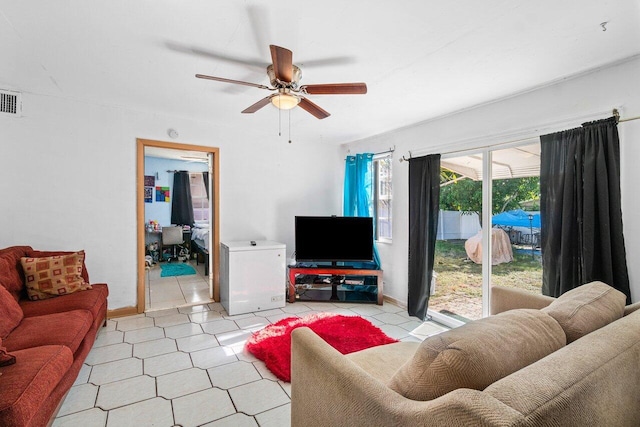 living room featuring ceiling fan and light tile patterned flooring