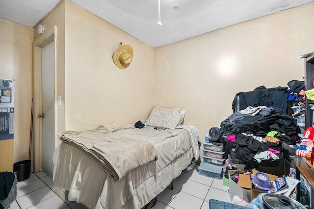 bedroom featuring light tile patterned flooring and a textured ceiling